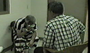 Investigator interviewing a subject during a high-stakes interrogation in an interview room