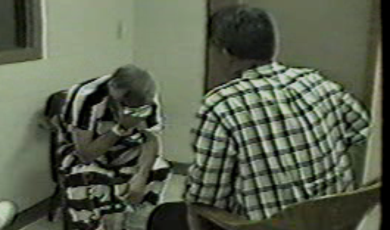 Investigator interviewing a subject during a high-stakes interrogation in an interview room